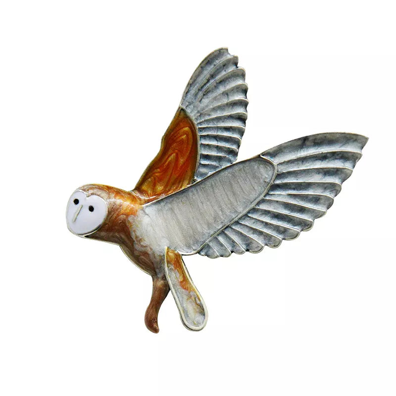 Whimsical silver and marbled stone owl brooch with detailed etching and playful cartoon-like eyes in flight - unique animal jewelry accessory